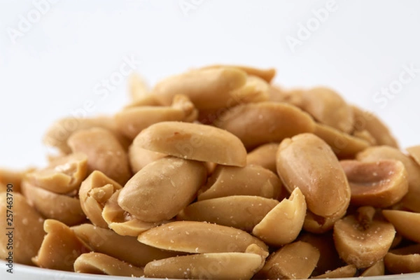 Obraz Roasted peanuts and salt in a bowl