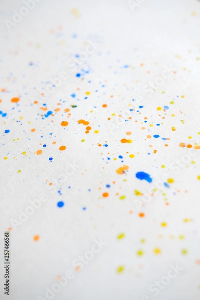 Fototapeta Watercolor splash background. Orange, yellow, blue colorful paint drops texture.  Paint splatter, poster for your design. Vertical