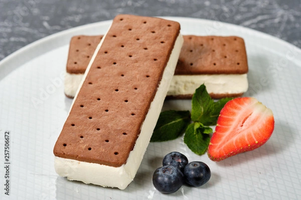 Fototapeta vanilla ice cream with cookies on a white plate with berries