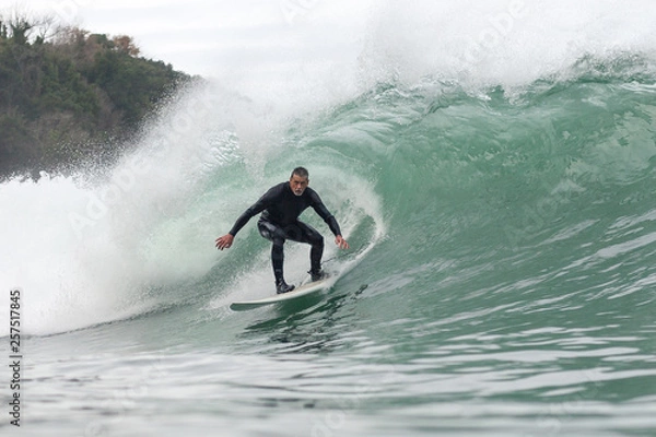 Obraz 68 year old man surfing a big wave 