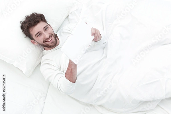 Obraz background image .attentive man digital tablet.