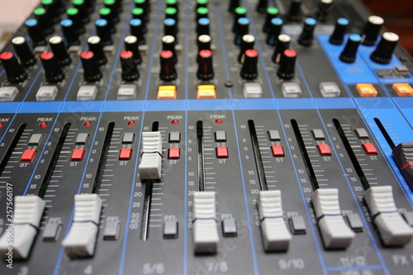 Fototapeta Audio mixer control panel with buttons and sliders.