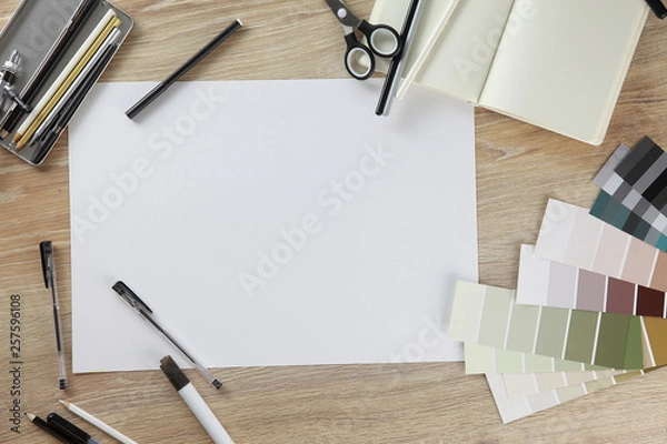 Fototapeta Collage view from above. View on top. Workspace artist or designer. paper on the wooden table. Template for a poster, postcards, ads. White blank sheet of paper. gamma: black, white, gray