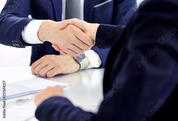 Fototapeta Group of business people or lawyers shaking hands finishing up a meeting , close-up. Success at negotiation and handshake concepts
