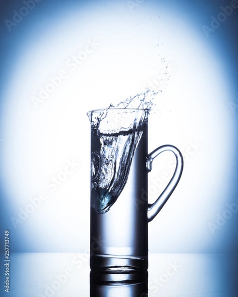Obraz ice drops in glass jug full of water.