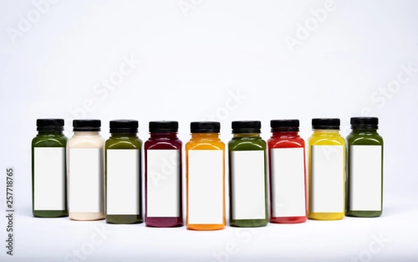 Obraz Bottles of juice on an isolated white background with blank labeling