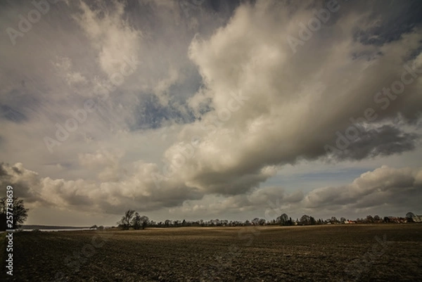 Fototapeta Amazing light and clouds over field