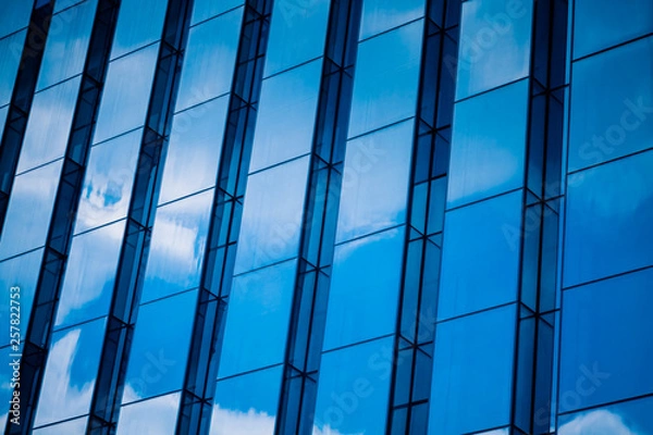 Fototapeta Clouds Reflected in Windows of Modern Office Building.