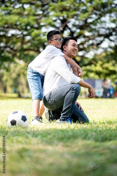 Obraz Happy children and parents playing in the park. Concept family relaxation.