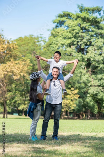 Obraz Happy children and parents playing in the park. Concept family relaxation.