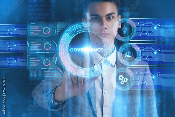 Fototapeta The concept of business, technology, the Internet and the network. A young entrepreneur working on a virtual screen of the future and sees the inscription: Governance