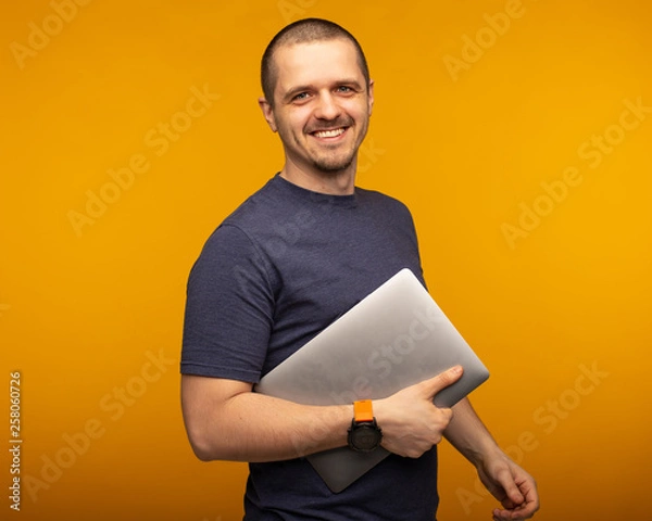 Obraz Man developer or freelancer or designer holding laptop