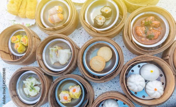 Fototapeta close up of variety dim sum in bamboo basket
