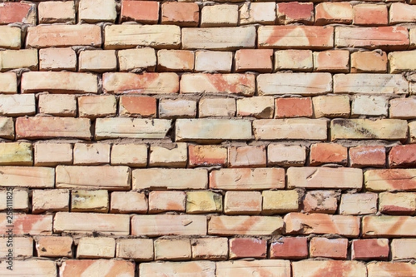 Fototapeta A wall of bricks in a house under construction as an abstract background