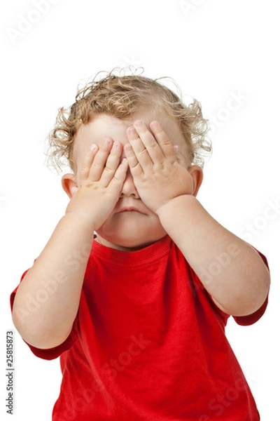 Fototapeta Baby covering eyes with hands playing peekaboo isolated on white