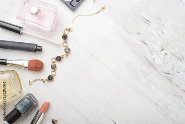 Fototapeta Set of professional cosmetics, makeup tools and accessories on a white marble background with copy space for text. concept of beauty, fashion. flat composition of the frame, top view.Flat lay