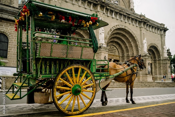 Obraz Horse Drawn Carriage parking in front of Malate church , Manila Philippines