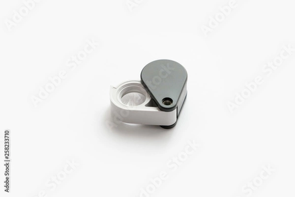 Fototapeta Magnifying glass for diamonds or see the amulet Isolated on a White Background.