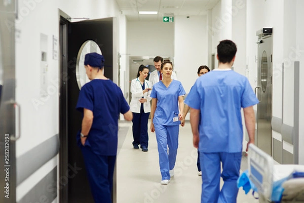 Obraz Doctors walking through corridor in hospital