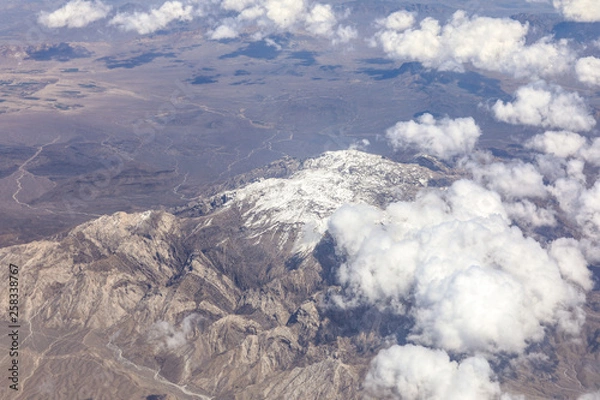 Fototapeta view of the snowy mountain landscape from an airplane