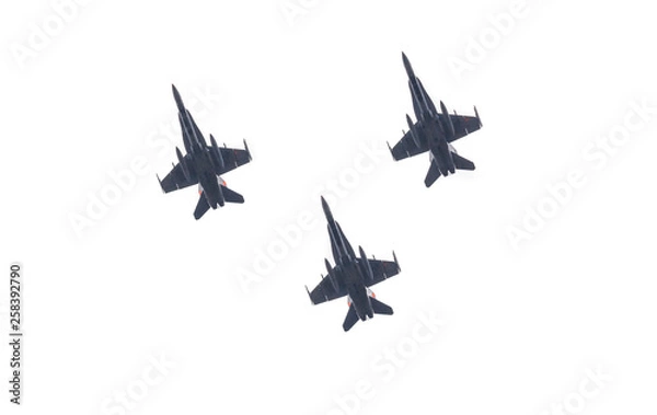 Fototapeta Group of three army fighter jets shot from below. Silhouettes of military war aircrafts with bombs and missiles ready to attack isolated on white background.