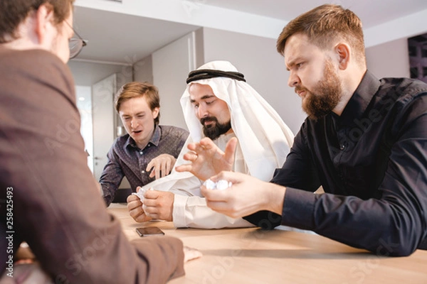 Fototapeta Three colleagues discussing business using a laptop. 
 Business Executives Shoccked By Poor Revenue Reports