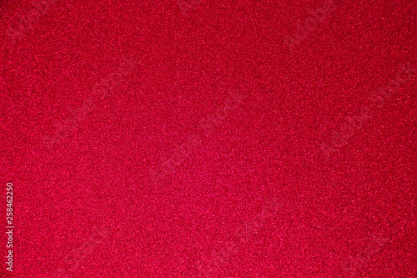 Fototapeta An abstract red background made of twinkling glitter that is great for a background for Christmas and other celebrations.
