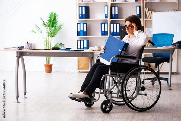 Fototapeta Female employee in wheel-chair at the office  