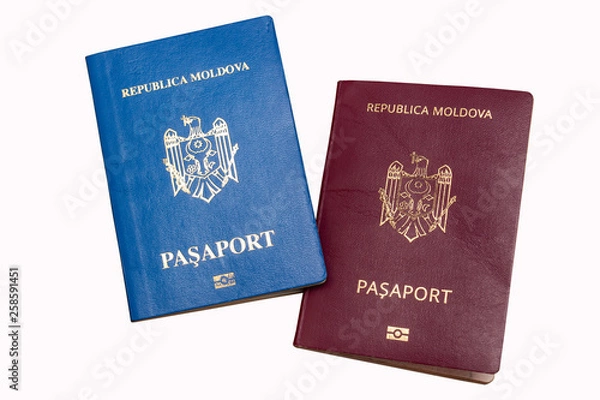 Obraz Biometric passports of citizens of the Republic of Moldova of red and blue colors isolated on white background. Covers of documents of different colors. Inscription - Republic of Moldova, Passport 