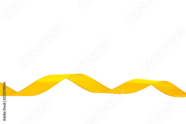 Fototapeta Yellow ribbon isolated on white background. Spiral of satin ribbons. Festive decor on a white background.