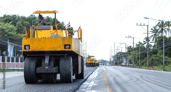 Obraz Close view on the road roller working on the road construction site.