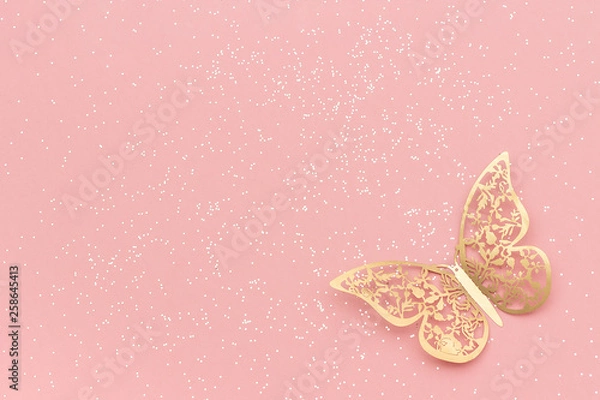 Obraz Sparkles glitter and gold tracery butterfly on pink pastel trendy background. Festive background, template