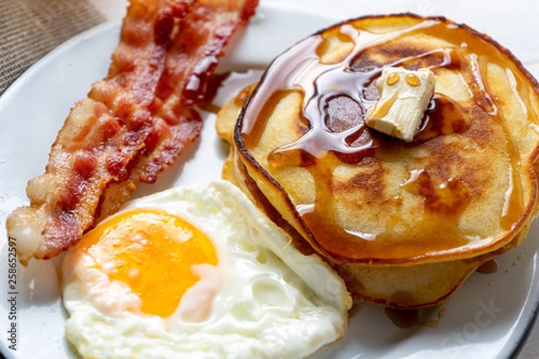Fototapeta American breakfast with egg, pancake and bacon