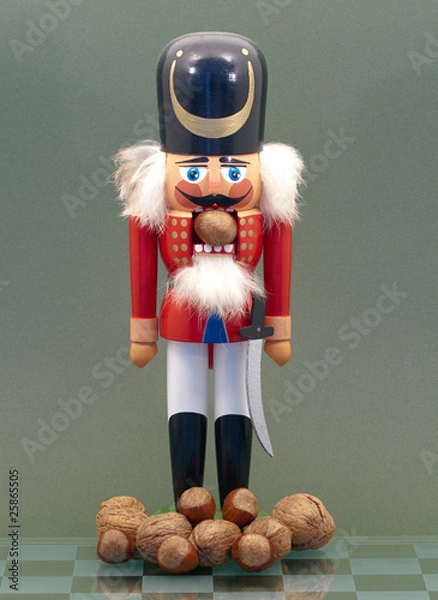 Obraz Wooden Nutcracker with Nuts Isolated on a Green Background.