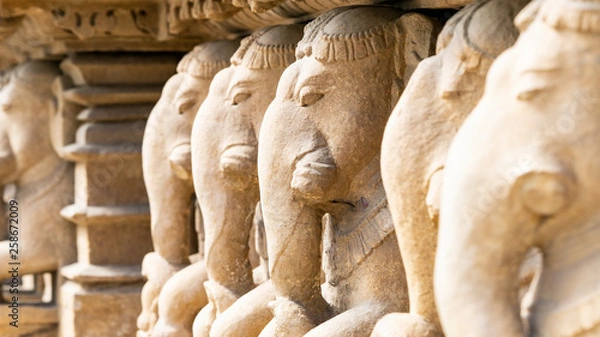 Fototapeta ancient stone sculptures carved into the wall of the temple