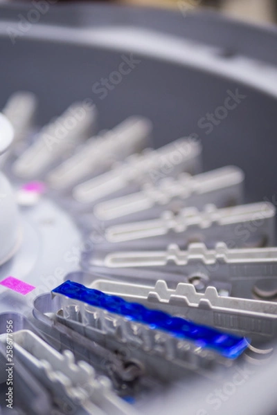 Fototapeta Part of centrifuged machine in hospital’s laboratory room .The blue line is gel card cover slip.(selective focus)