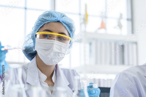 Fototapeta Asian young girl student scientist researching  and learning in a laboratory.