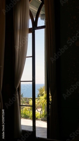 Obraz window with blue curtains