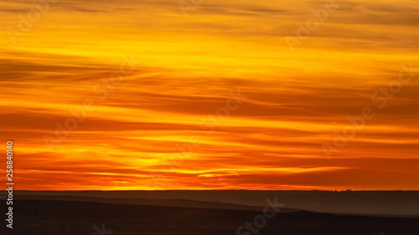 Obraz Dramatic orange and yellow sky with clouds at sunset