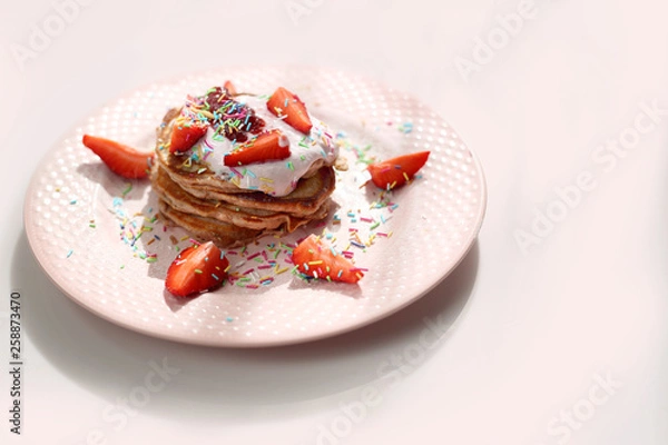 Obraz Pancakes with strawberries, cottage cheese and colorful sugar sprinkles.