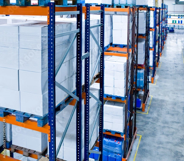 Obraz Pallets with boxes and drums in the warehouse