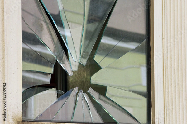 Obraz square window with broken glass by stone like star closeup
