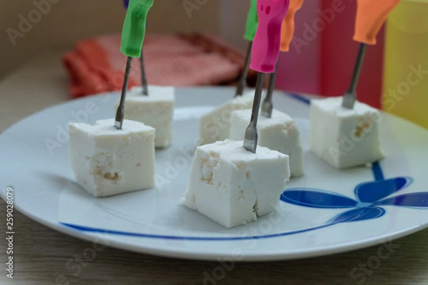 Fototapeta Cheese cubes with toothpicks.