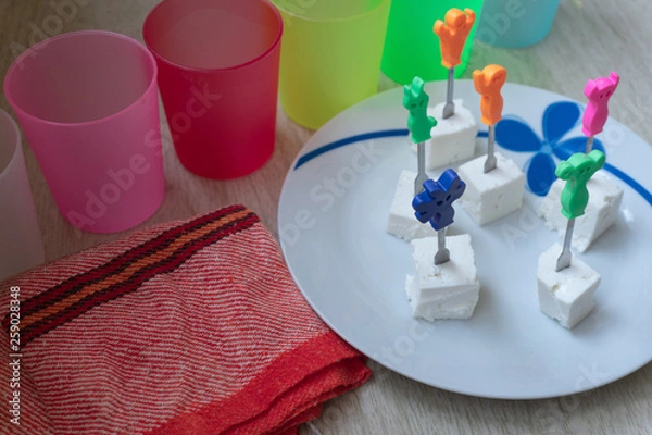 Fototapeta Cheese cubes with toothpicks.