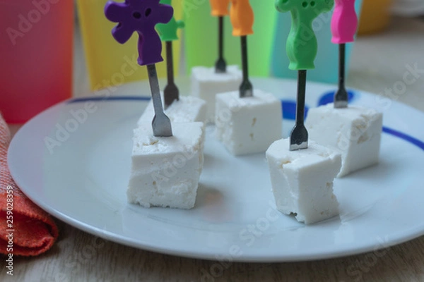 Fototapeta Cheese cubes with toothpicks.