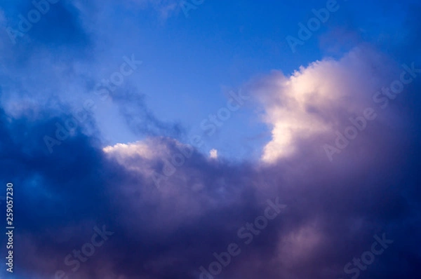 Fototapeta blue evening sky with white and gray clouds; cumulus. background; nature