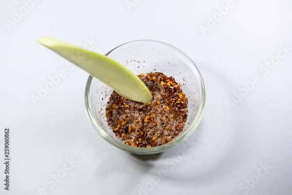 Obraz Thailand snack traditional ,Raw mango with salt and chile pepper sauce on white plate.