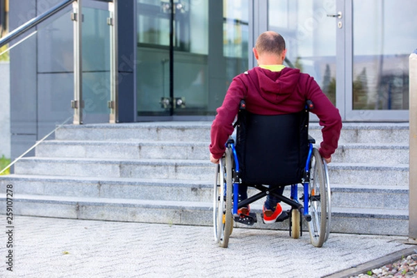 Obraz man on wheelchair and steps