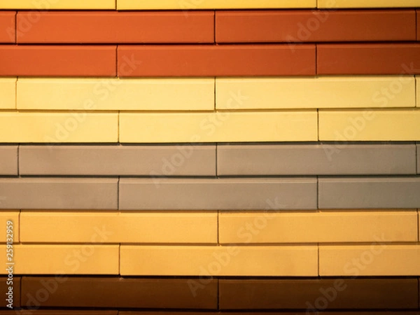Fototapeta abstract pattern wall made of different colors bricks - orange, red, brown, gray and yellow