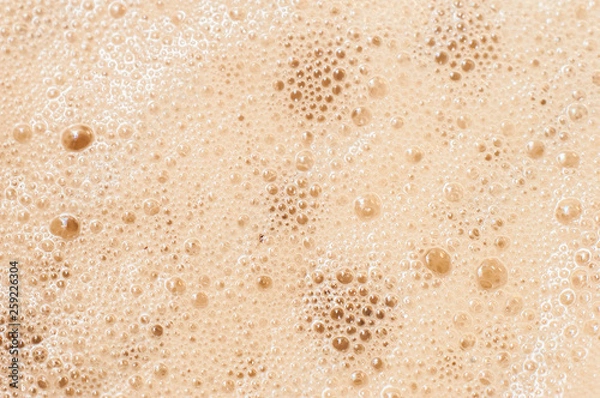 Fototapeta Desktop wallpaper of a computer or a phone made of frothy foam with blobs from morning coffee with milk or cream
